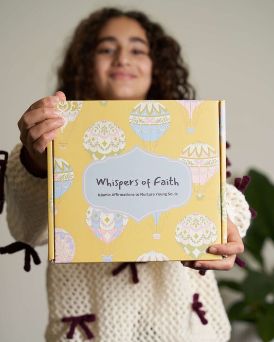Person holding a book titled 'Whispers of Faith' with decorative cover