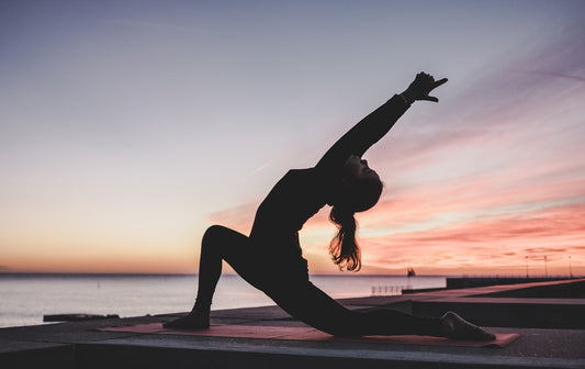 Hands resting open on knees in a meditative pose representing somatic trauma healing and body-based therapy in NSW Sydney